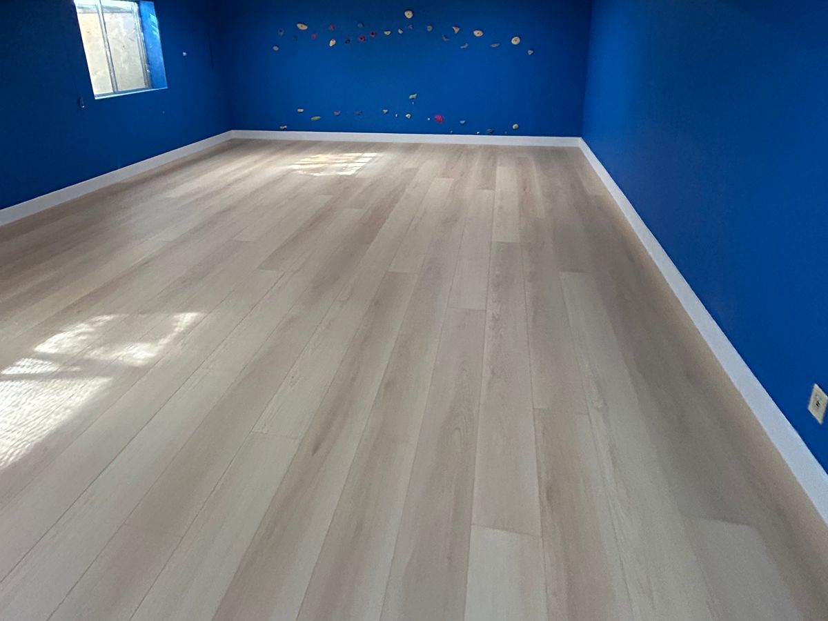 Wood-look luxury vinyl plank installation in a Denver basement floor over a concrete slab